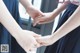 A couple of women holding hands in front of a window.