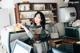 A woman sitting at a counter in a coffee shop.